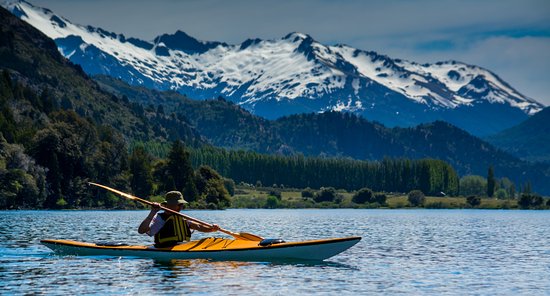 Kayaking on a lake surrounded by Patagonian mountains