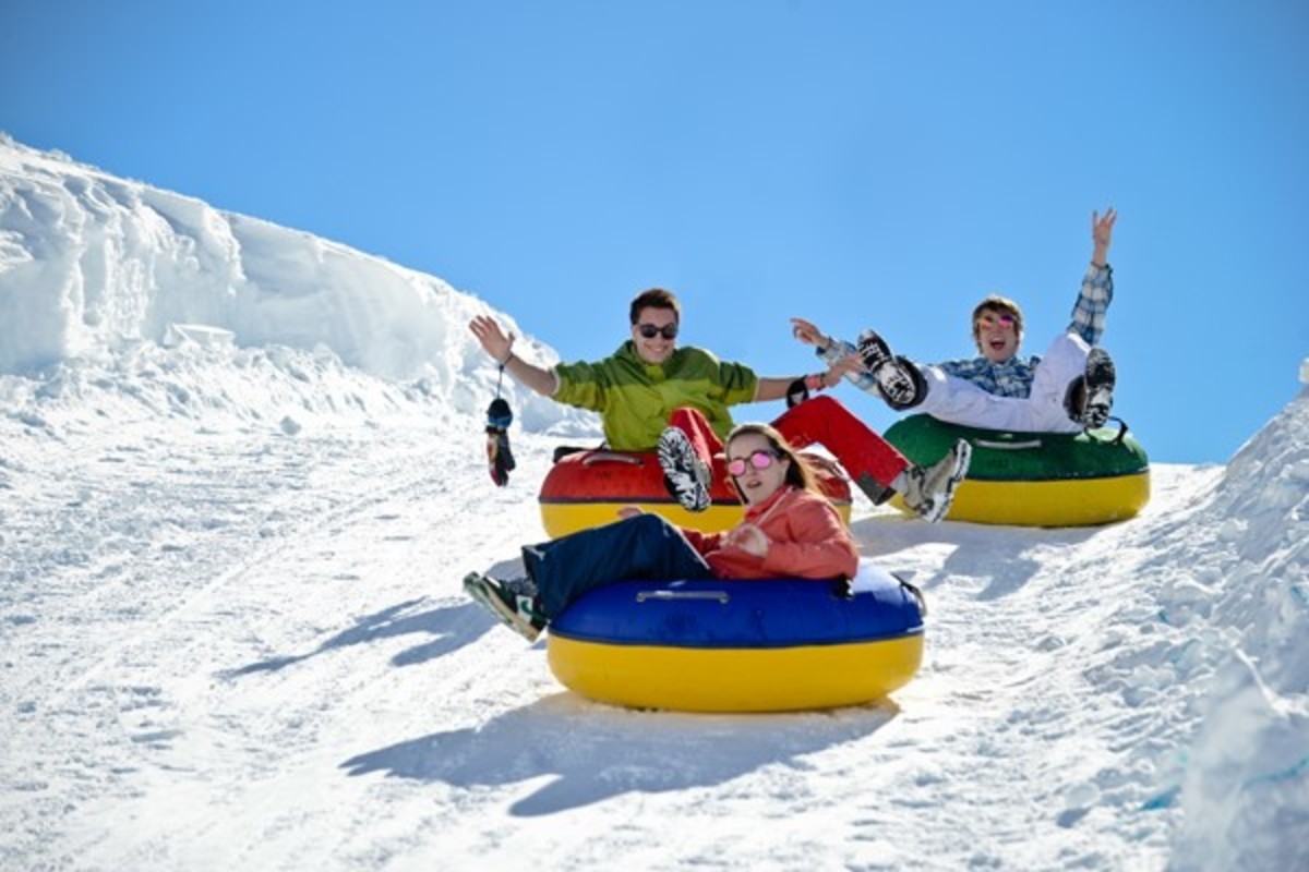 Visitors enjoying snowtubing in a snow park